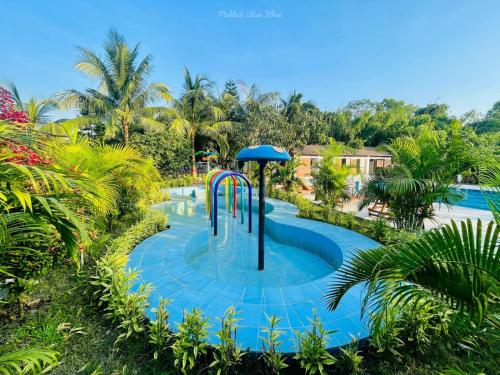a pool with a water slide in a resort at Kokomo Sunset Resort in Gazipur