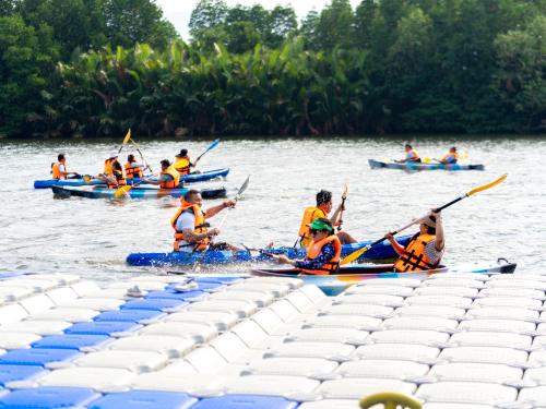 a group of people in kayaks on the water at Wonderland Suites and Resort in Sihanoukville