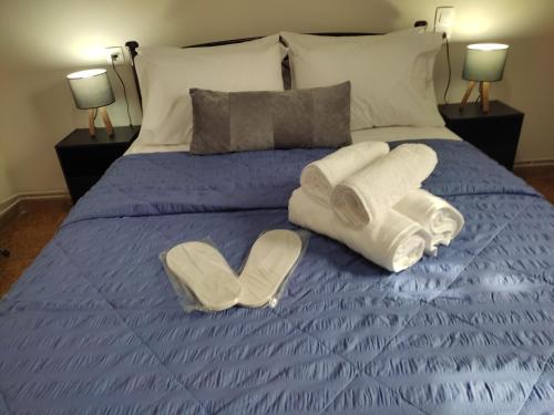 a bed with two towels and two hearts on it at D&G City Centre Home in Heraklio