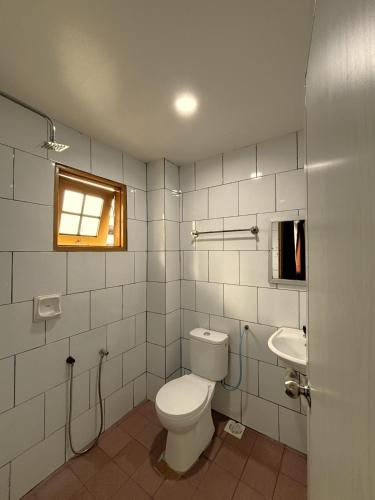 a bathroom with a toilet and a sink at Cool Point Hotel in Tanah Rata
