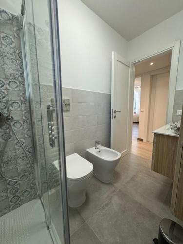 a bathroom with a toilet and a glass shower at La Foce in Savona