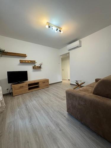 a living room with a couch and a flat screen tv at La Foce in Savona