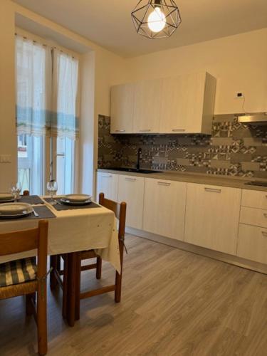 a kitchen with a table and chairs and a dining room at La Foce in Savona