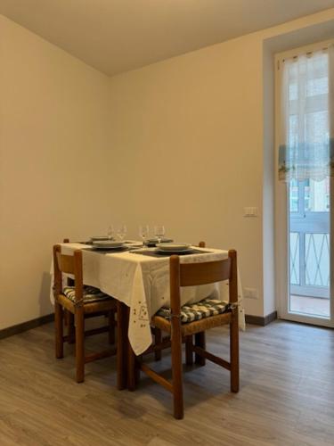 a table with two chairs and a table with glasses on it at La Foce in Savona