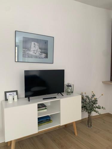 a white entertainment center with a flat screen tv at La Lum in Varallo