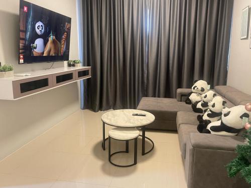 a living room with a couch with stuffed animals on it at IPOH TAMBUN THE COVE Your Ultimate Relaxation Getaway777 -3 BED ROOM -NO PETS ALLOW in Ipoh