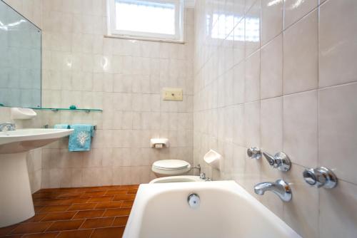 a bathroom with a tub and a toilet and a sink at StarFish in Santa Margherita Ligure