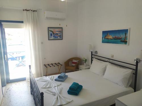 a bedroom with a bed with towels on it at AGORA CENTER Building - Room 20 in Ios Chora
