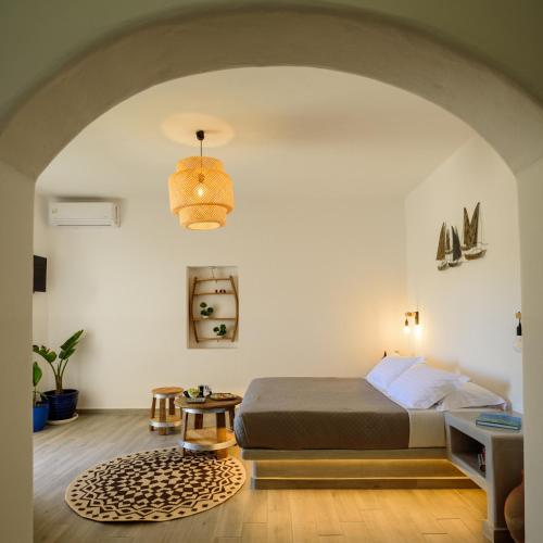 a bedroom with a bed and a table in a room at Athiri Luxury Suites in Perivolos