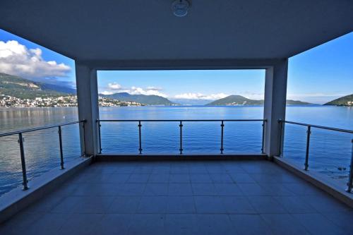 a view from the balcony of a house overlooking the water at Hotel Vienna in Herceg-Novi