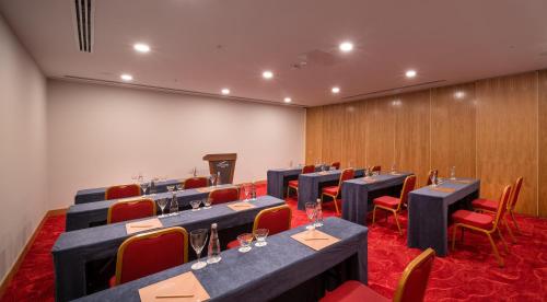 a conference room with tables and chairs and a podium at Concorde Tower Hotel & Casino in North Nicosia