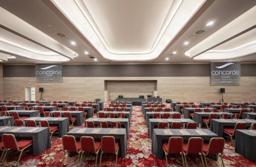 a conference room with tables and chairs in it at Concorde Tower Hotel & Casino in North Nicosia