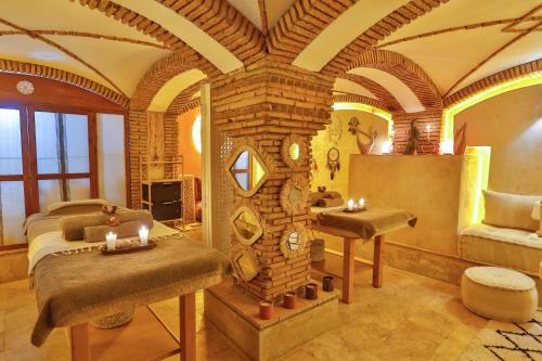 a bedroom with a bed and a sink in a room at Riad Dar L'Oussia & SPA in Essaouira