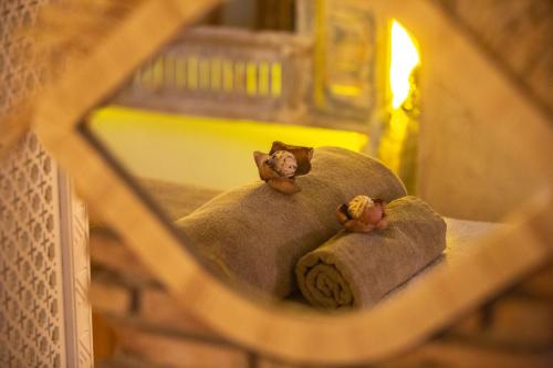 two teddy bears sitting on top of a pillow at Riad Dar L'Oussia & SPA in Essaouira