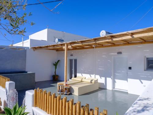 a patio with a couch under a pergola at Athiri Luxury Suites in Perivolos
