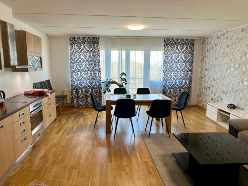 a kitchen and dining room with a table and chairs at Comfortable apartament to stay in Tallinn in Tallinn