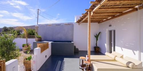 a patio with a view of a house at Athiri Luxury Suites in Perivolos
