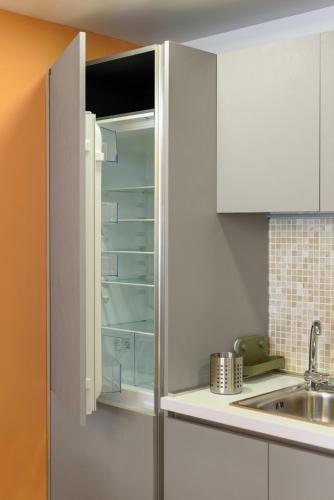 a kitchen with white cabinets and a sink at Astria Brasil - Complex Novum in Olimp