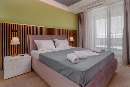 a bedroom with a large bed with two pillows on it at Astria Brasil - Complex Novum in Olimp
