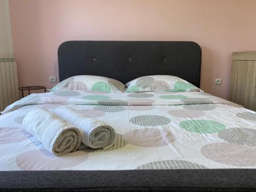a large bed with pillows and towels on it at Portorož Apartments Franca in Portorož