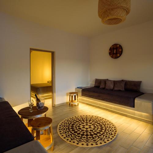 a bedroom with a bed and a table and a mirror at Athiri Luxury Suites in Perivolos