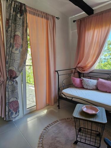 a bedroom with a bed and a large window at Apartmani VERONA in Bijela