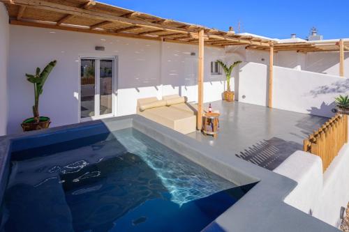 a swimming pool in the middle of a house at Athiri Luxury Suites in Perivolos