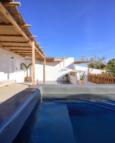 a swimming pool in the backyard of a villa at Athiri Luxury Suites in Perivolos