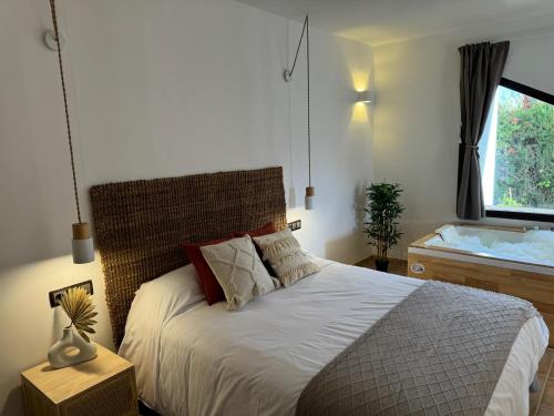 a bedroom with a large bed and a window at KAUKABA-Apartamentos Rurales- Adults Only in Pozo Alcón