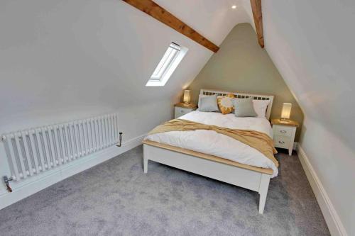 a bedroom with a white bed in a attic at One Norwood - Grade 2 Listed, Central 3 Bed in Beverley