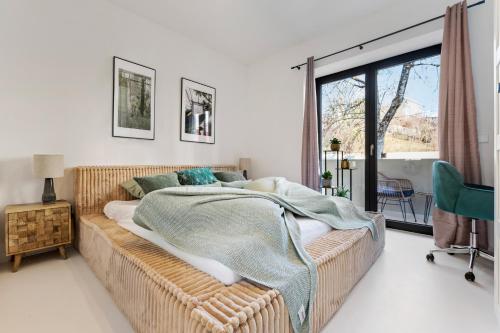 a bedroom with a bed with a blanket on it at Stuttgart Lux Living - Stilvolles Wohnen Im Zentrum in Stuttgart