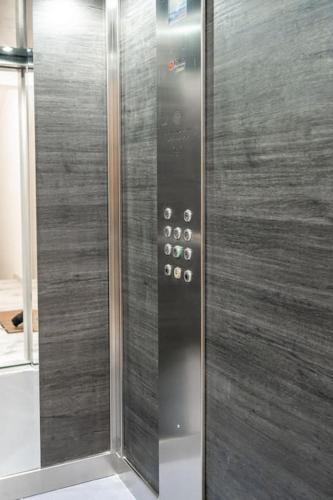 a elevator with a glass door with buttons on it at LA88 Cityway Penthouse in Il-Gżira