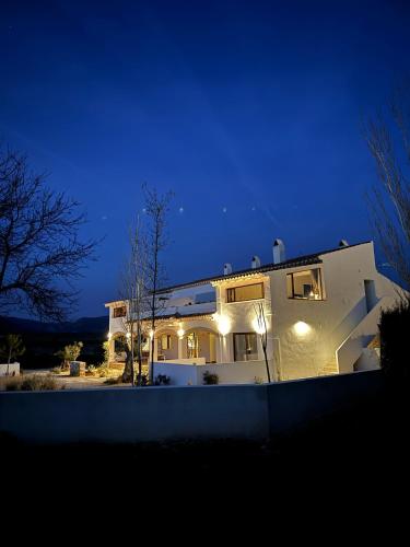 a white house at night with lights on at KAUKABA-Apartamentos Rurales- Adults Only in Pozo Alcón