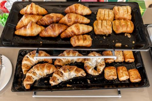 a tray of food with croissants and other foods at Golden Sand in Plaka