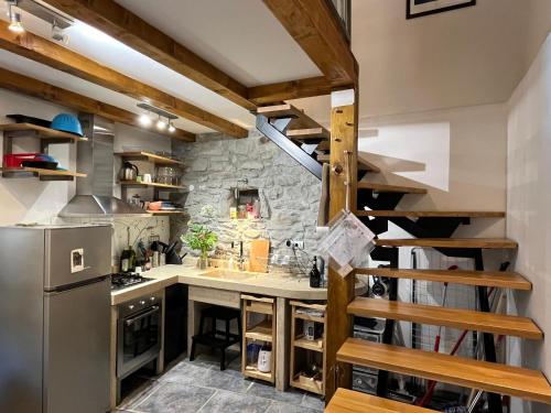 a kitchen with a staircase leading up to a loft at Kate's Townhouse in Buzet