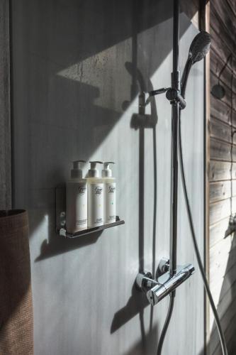 a group of four bottles on a shelf on a wall at ES CUCONS RURAL HOTEL in San Antonio