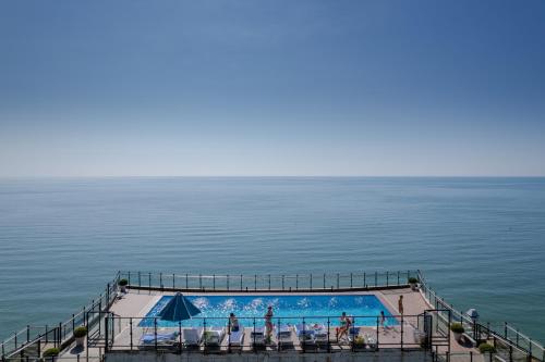 a swimming pool on the edge of the ocean at Panorama Kvariati in Kvariati