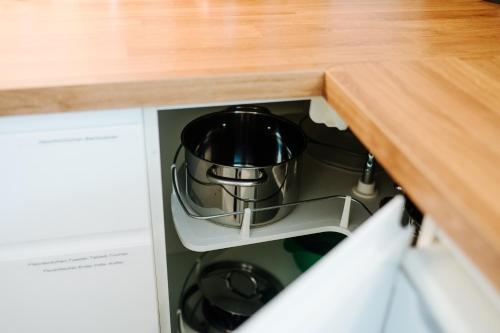 a tea pot is sitting inside of a cabinet at Villa Levin - 56qm, bis 4 Personen, free Wifi & parken in Steudnitz