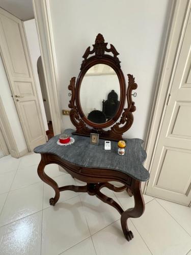 a dressing table with a mirror on top of it at Palazzo Quey in Lecce