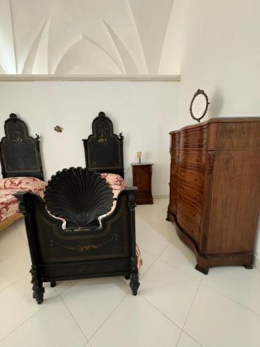 two beds and a dresser in a room at Palazzo Quey in Lecce