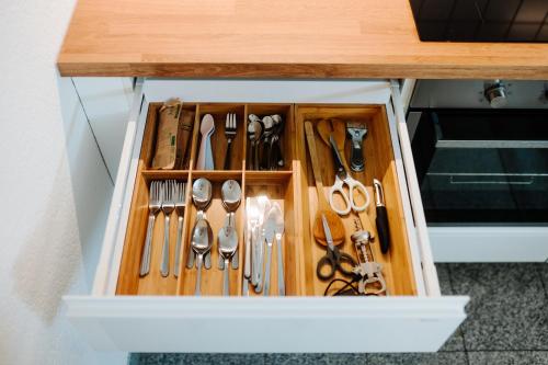 a drawer filled with utensils on a table at Villa Levin - 56qm, bis 4 Personen, free Wifi & parken in Steudnitz