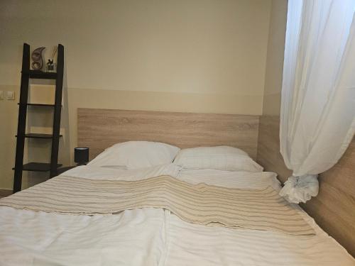 a bed with white sheets and pillows in a bedroom at Hotel Taurus in Ostrava