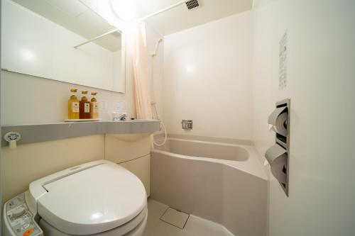 uma pequena casa de banho com WC e banheira em Meitetsu Inn Nagoya Kanayama em Nagoia