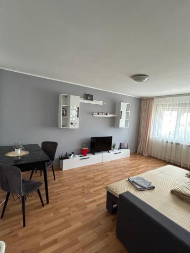 a living room with a table and a dining room at SJ Apartment in Tulcea