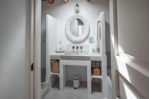 a bathroom with a sink and a mirror at ES CUCONS RURAL HOTEL in San Antonio
