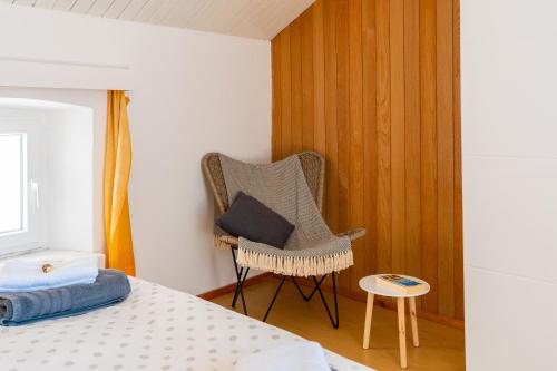 a bedroom with a chair with a pillow on it at Apartment Jessica in Korčula