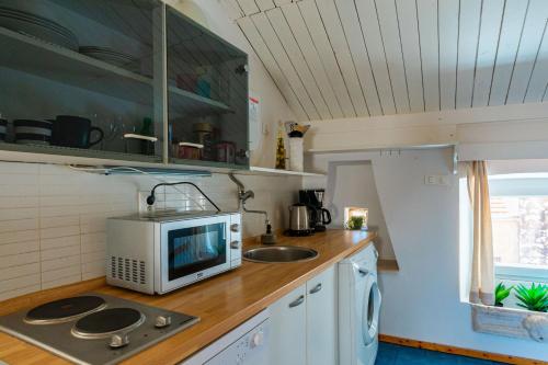 a kitchen with a microwave and a sink at Apartment Jessica in Korčula