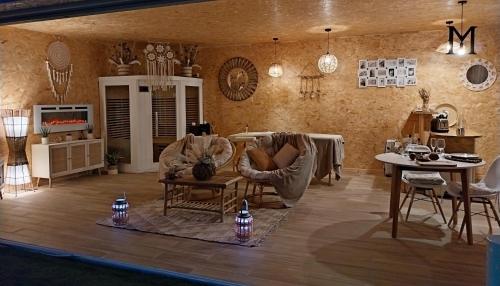 a living room with chairs and a table at Le Clos FMR Insolite - "F"anny Carcassonne in Malves-en-Minervois