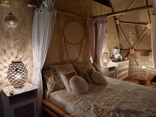 a bedroom with a canopy bed with two night stands at Le Clos FMR Insolite - "F"anny Carcassonne in Malves-en-Minervois