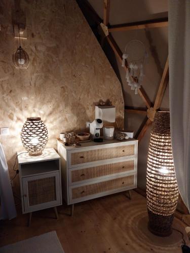 a room with a dresser and two lamps in a attic at Le Clos FMR Insolite - "F"anny Carcassonne in Malves-en-Minervois